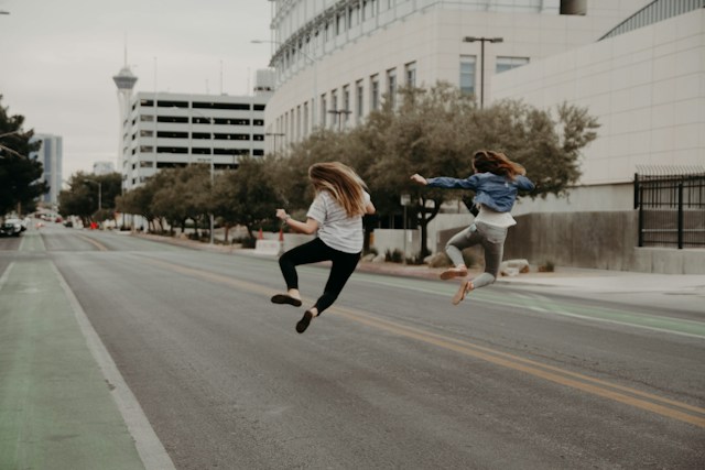 two real estate investors celebrating with a jump in the air after successful real estate syndication deal