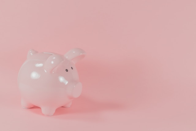 a pink pig savings jar for saving money tips and investing at the same time